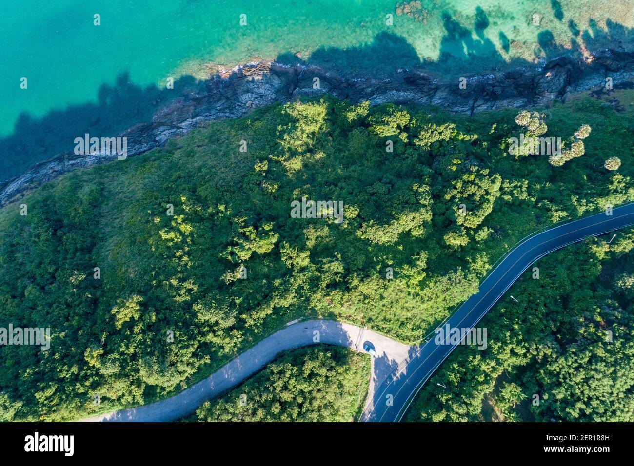 Aerial view top view seashore with asphalt road curve in Tropical island Amazing nature view Beautiful island in Phuket Thailand. Stock Photo