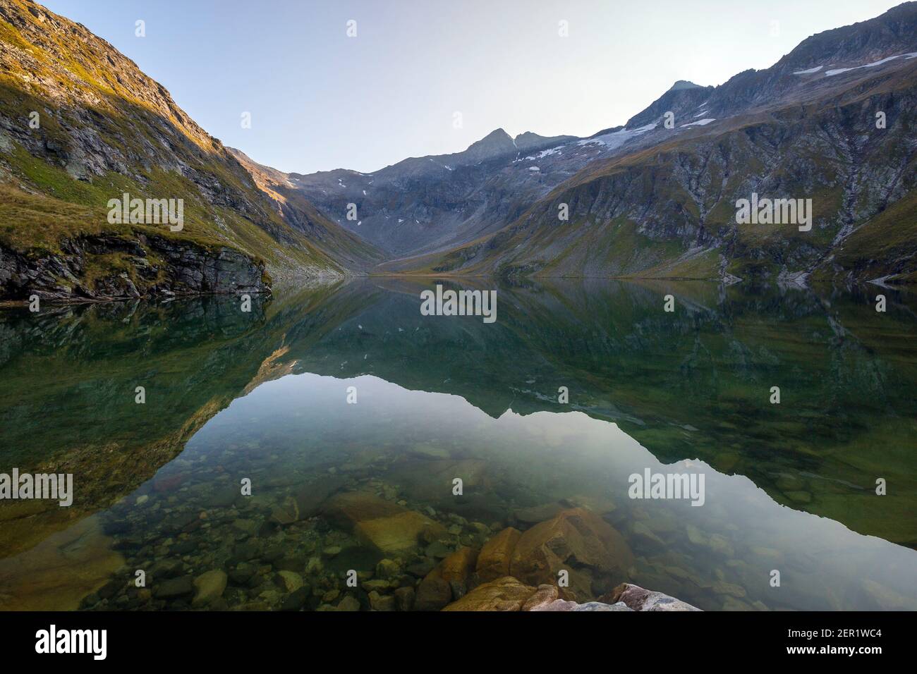 Kratzenbergsee alpine lake. Reflections on lake water. Hollersbachtal. Venediger mountain group. Austrian Alps. Europe. Stock Photo