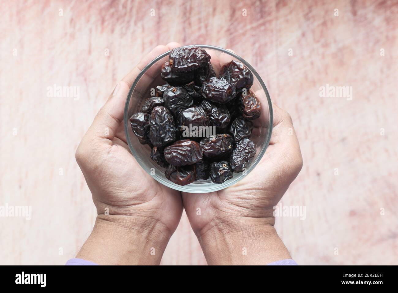 close up of fresh date fruit in a bowl on table  Stock Photo