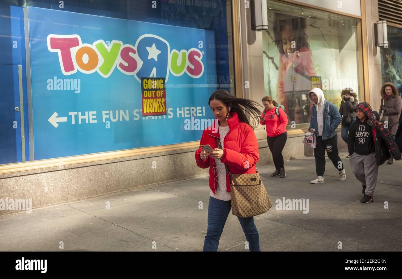Signs posted on the window of the Toys R Us store in Times Square in