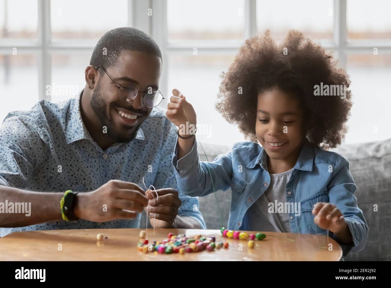 Happy Black father and daughter girl making decoration together Stock ...