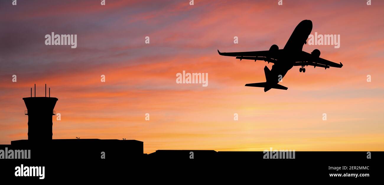 Silhouette of a plane landing at the airport against the background of sunset Stock Photo