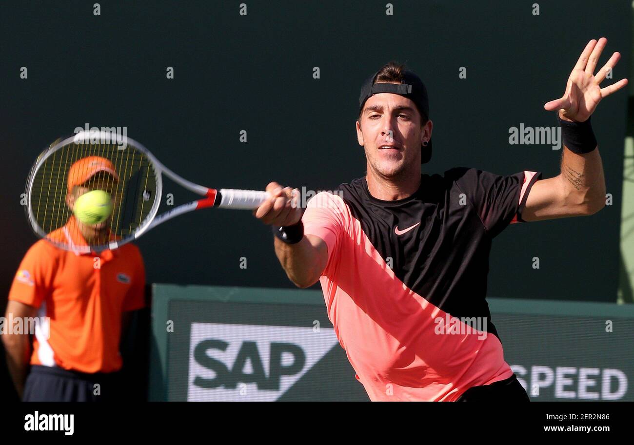 Thanasi Kokkinakis of Australia returns against Roger Federer of Switzerland  during the second round at the Miami Open at Crandon Park Tennis Center on  Key Biscayne, Fla., on Saturday, March 24, 2018.