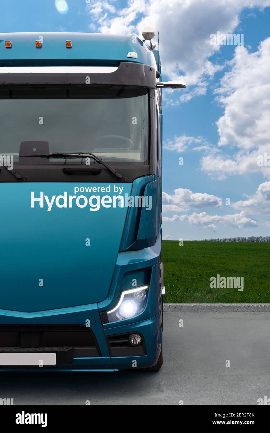 Truck on hydrogen fuel on a background of green field and blue sky Stock Photo
