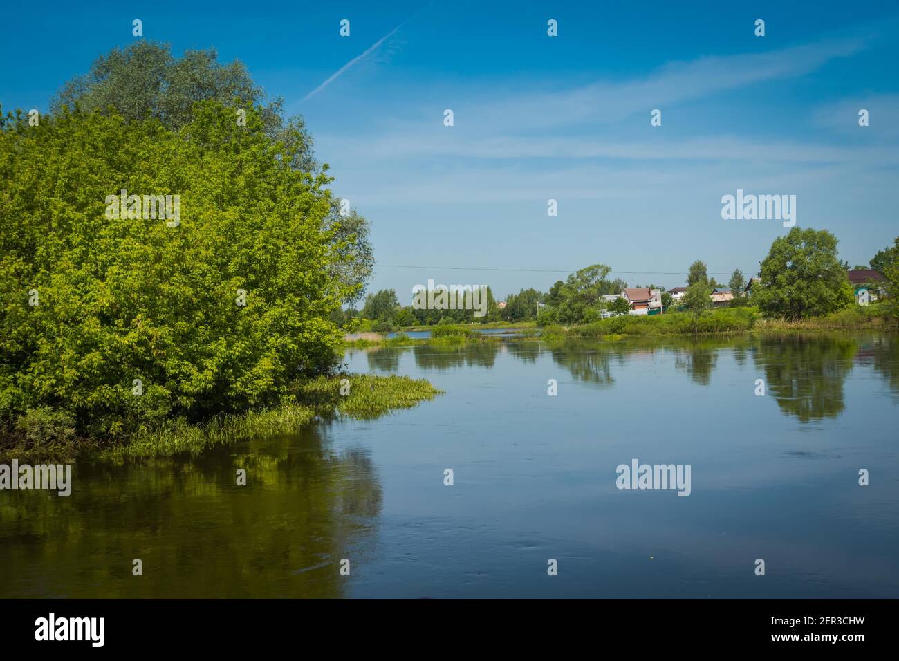 Summer rural landscape with river and blue sky background Stock Photo ...