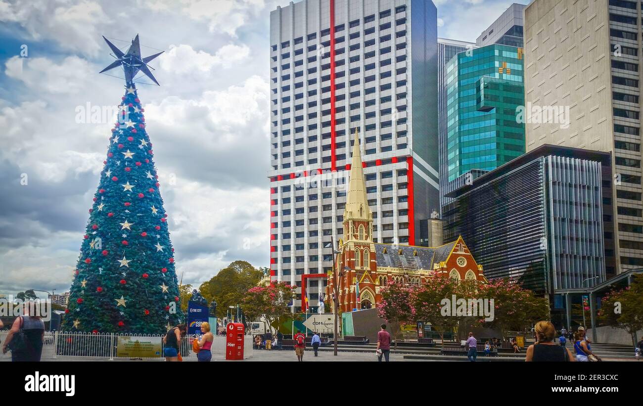 12-22-2014 Brisbane Australia - Solar Christmas tree and cute chapel with skyscrapers in background in the Central Business District Stock Photo