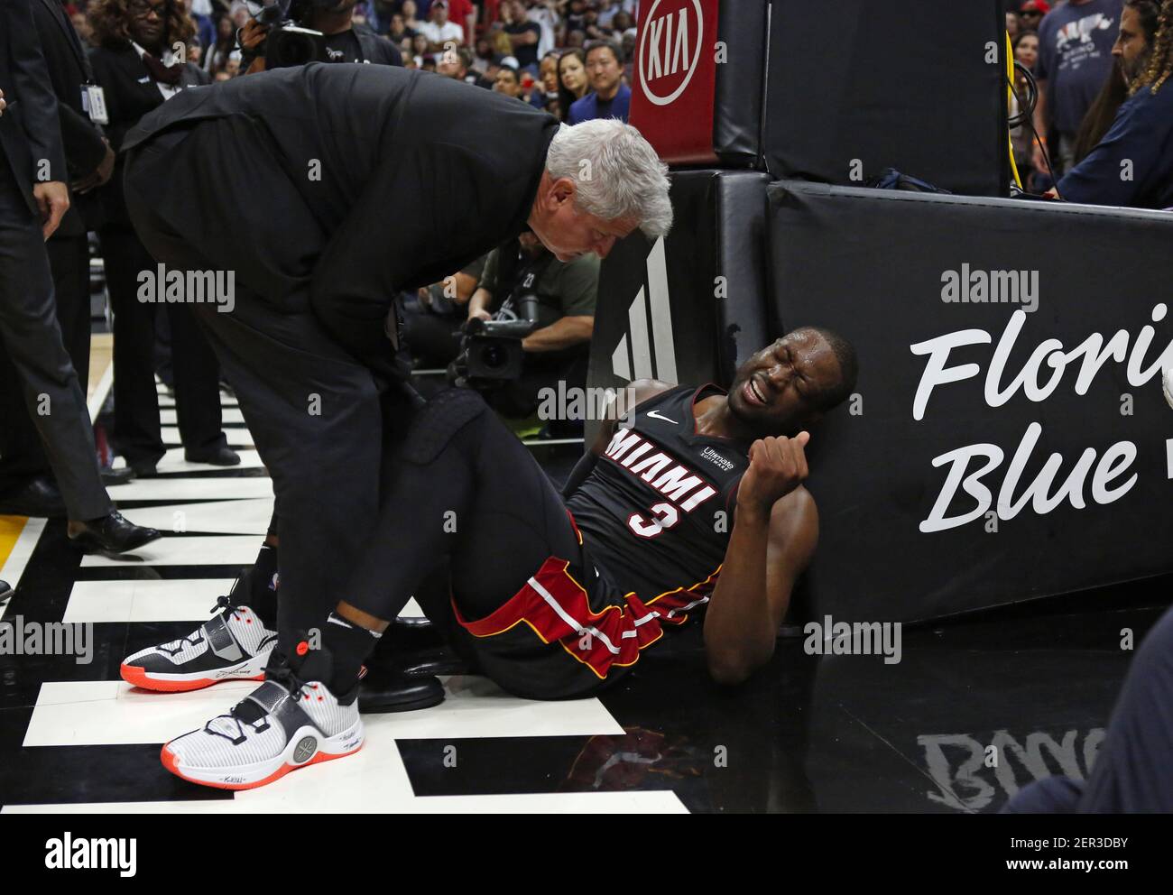 Miami Heat athletic trainer Jay Sabol works with guard Dwyane Wade after a  play during overtime against the Brooklyn Nets at the AmericanAirlines  Arena in Miami on Saturday, March 31, 2018. The