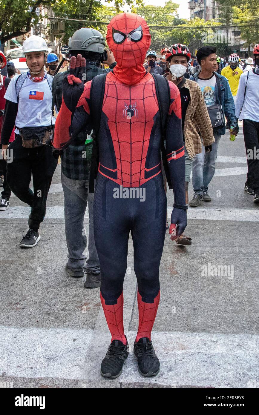 An anti military coup protester wearing a spiderman costume while making  the three finger salute stands during a demonstration against the military  coup.Myanmar police fire rubber bullets, real bullets, tear gas and