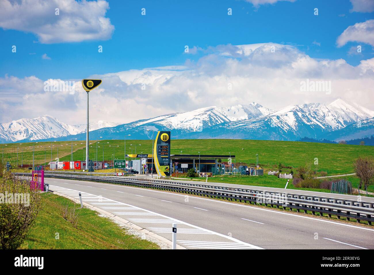 strba, slovakia - 01 MAY 2019: slovnaft gas station on a freeway. sunny scenery with green meadows beneath a blue sky with fluffy clouds. snow capped Stock Photo
