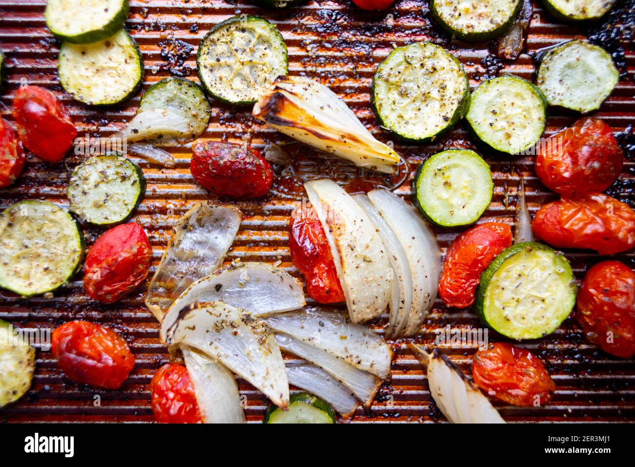 Food Sheet pan roasted vegetables zucchini onions cherry tomatoes Stock Photo