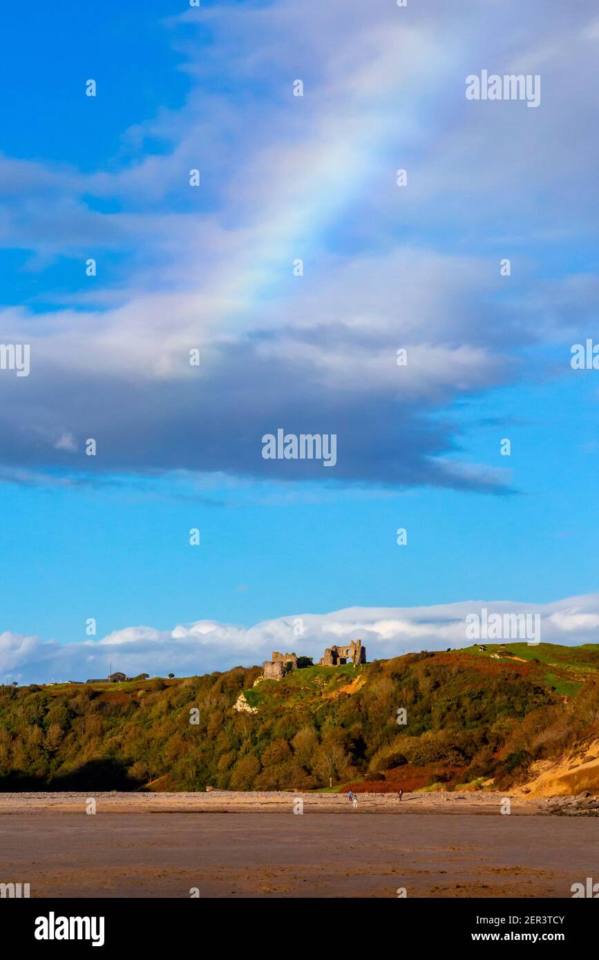 Rainbow over Pennard Castle at Three Cliffs Bay on the south coast of the Gower Peninsula near Swansea in South Wales UK Stock Photo