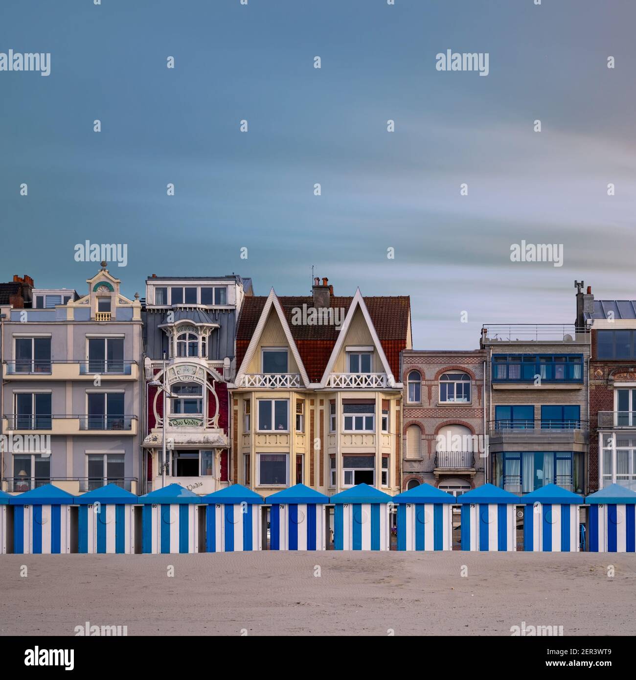 Colorful beach huts in Dunkirk against historic seaside buildings Stock Photo