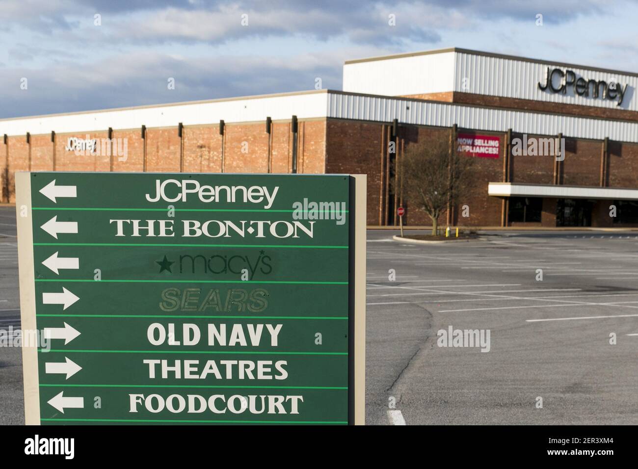 A shopping mall directional sign with the outlines of Sears and Macy's