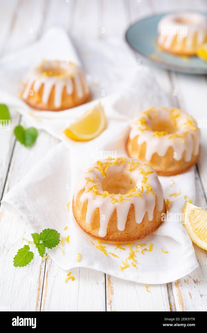 Tangy mini lemon bundt cakes topped with lemon glaze Stock Photo