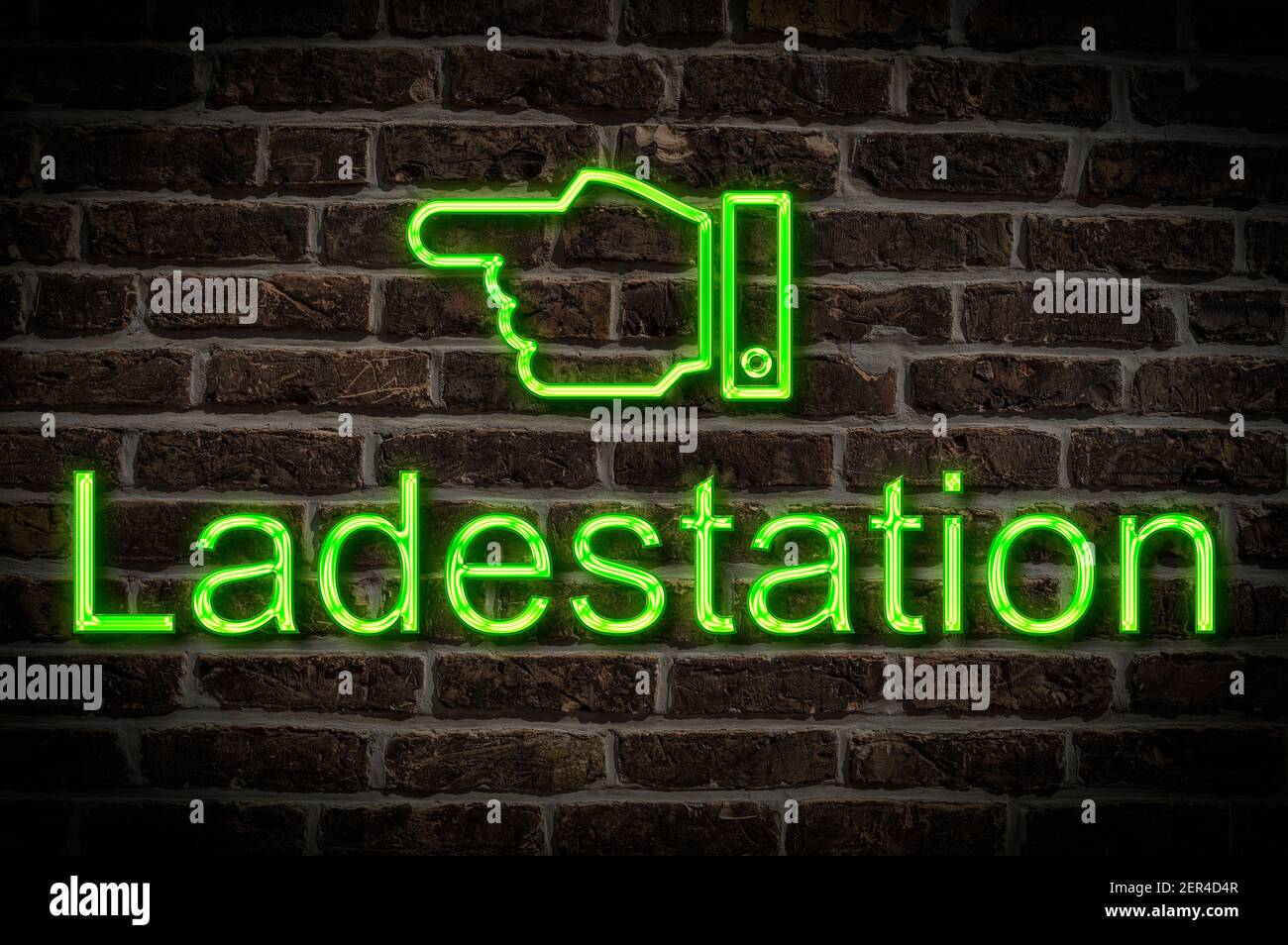 Detail photo of a neon sign on a wall with the inscription Ladestation (Charging station) Stock Photo