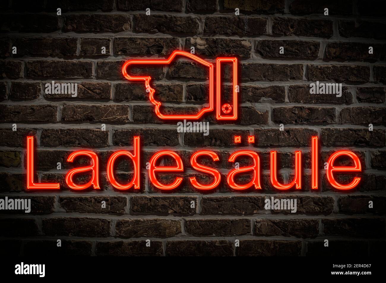 Detail photo of a neon sign on a wall with the inscription Ladesäule (Charging station) Stock Photo