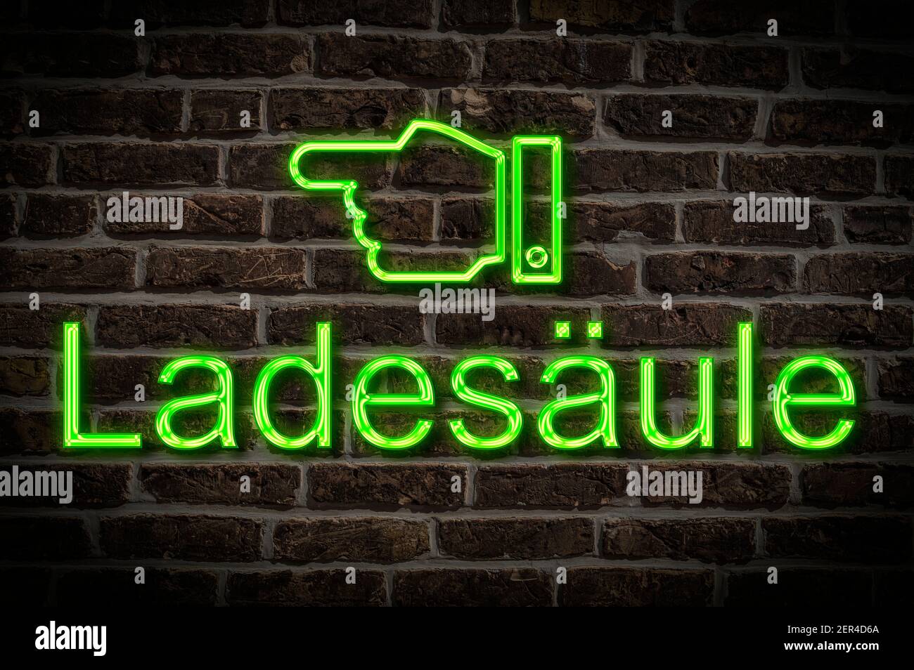 Detail photo of a neon sign on a wall with the inscription Ladesäule (Charging station) Stock Photo