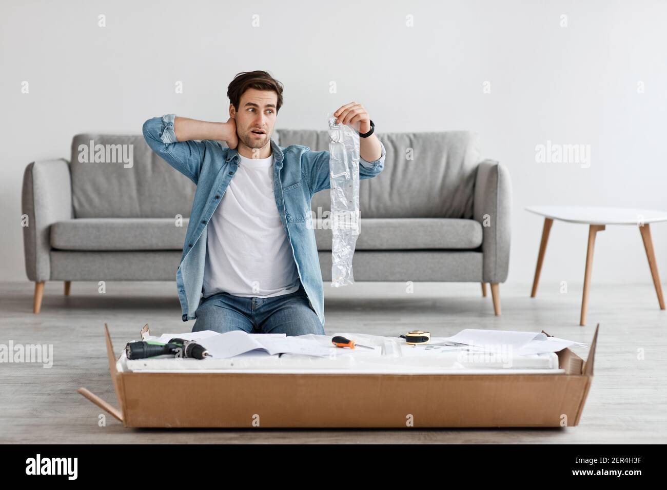 Difficult assembling of new furniture at home by yourself Stock Photo