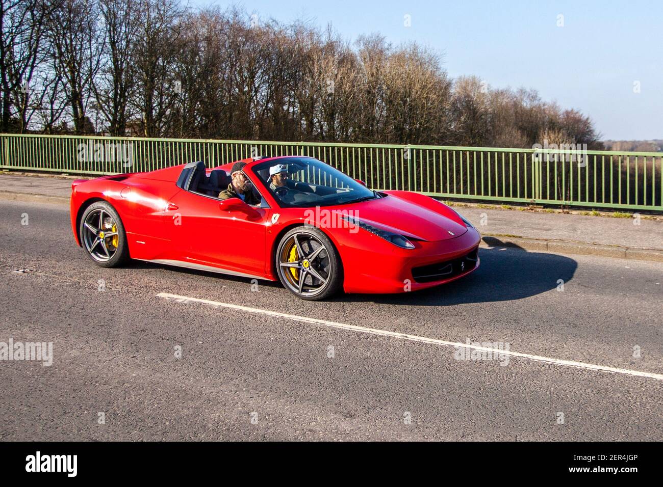 2014 red Ferrari 458 Spider Dct S-A sports car; Vehicular traffic, moving vehicles, cars, vehicle driving on UK roads, motors, motoring on the M6 motorway highway UK road network Stock Photo
