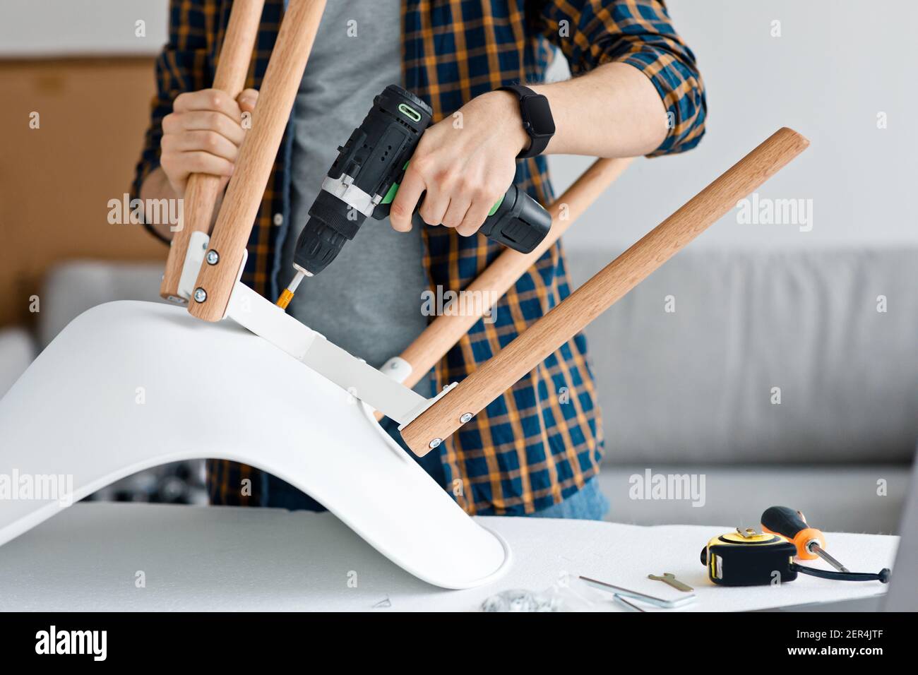 Craftsman collects and repairing with tools, assemble furniture with drill Stock Photo