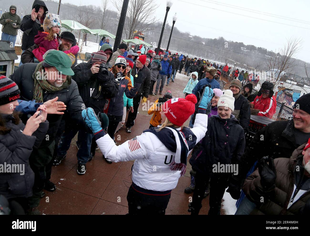 Jessie Diggins, Team USA Olympic gold medalist cross country skier, high-fives fans as hundreds brave snowy, blustery weather to honor Diggins with a parade on Saturday, April 14, 2018, in Stillwater, Minn. (Photo by David Joles/Minneapolis Star Tribune/TNS/Sipa USA) Stock Photo