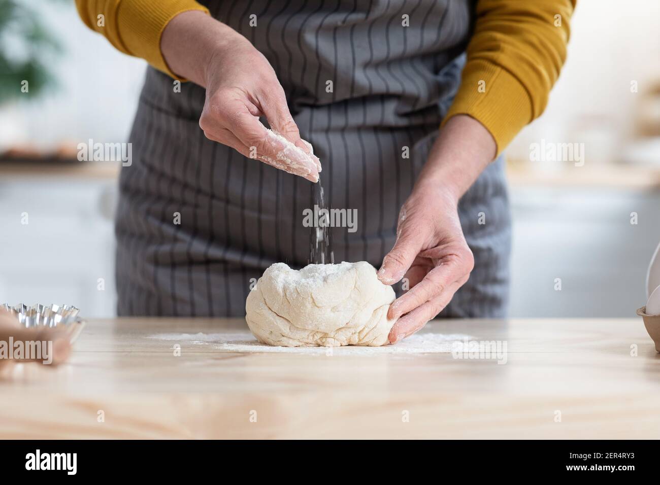 Female hands kneading dough, adding flour, kitchen interior Stock Photo ...