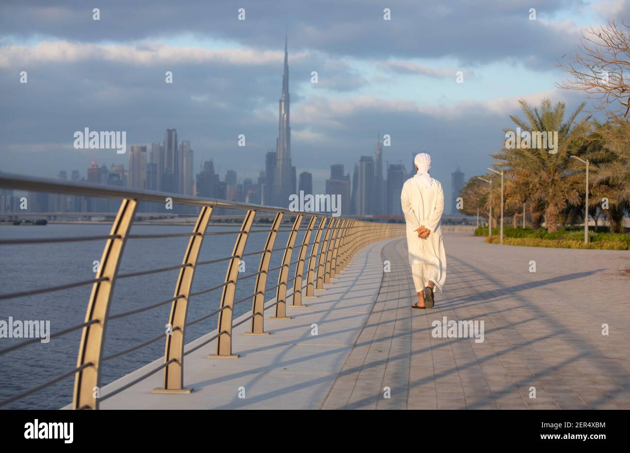 emirati Man at Al Jaddaf waterfront in Dubai with Burj Khalifa at the