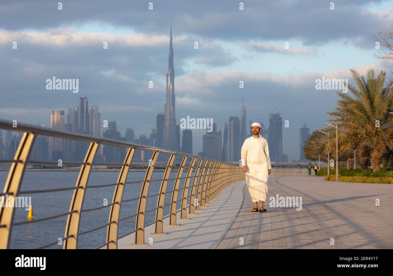 emirati Man at Al Jaddaf waterfront in Dubai with Burj Khalifa at the Background Stock Photo