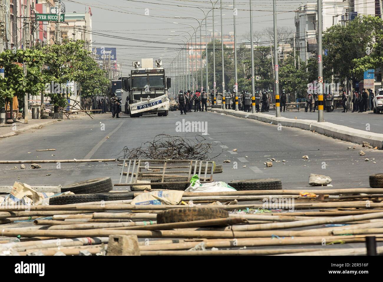 Mandalay, Myanmar. 28th Feb, 2021. Myanmar riot police clear the barricade to move forward during a protest against the military coup in Mandalay, Myanmar on Sunday, February. 28, 2021. Security forces continue to crackdown on demonstrations against the military coup. Photo by Xiao Long/UPI Credit: UPI/Alamy Live News Stock Photo