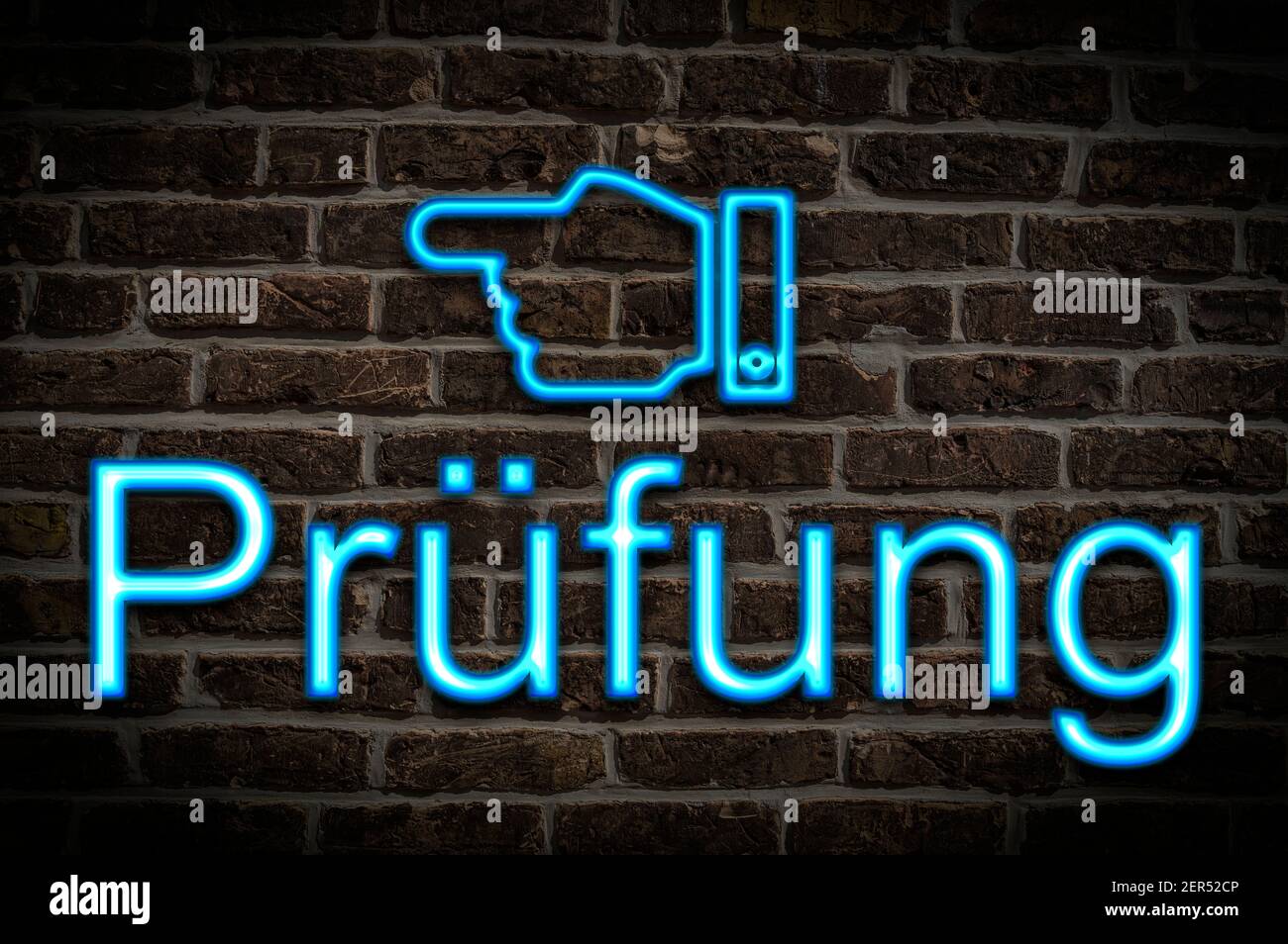 Detail photo of a neon sign on a wall with the inscription Prüfung (Test) Stock Photo
