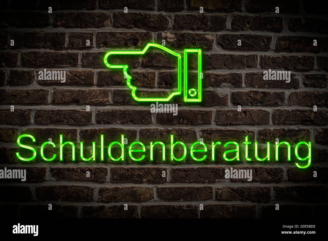 Detail photo of a neon sign on a wall with the inscription Schuldenberatung (Debt counselling) Stock Photo