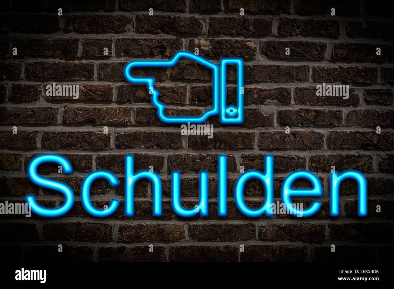 Detail photo of a neon sign on a wall with the inscription Schulden (Debts) Stock Photo