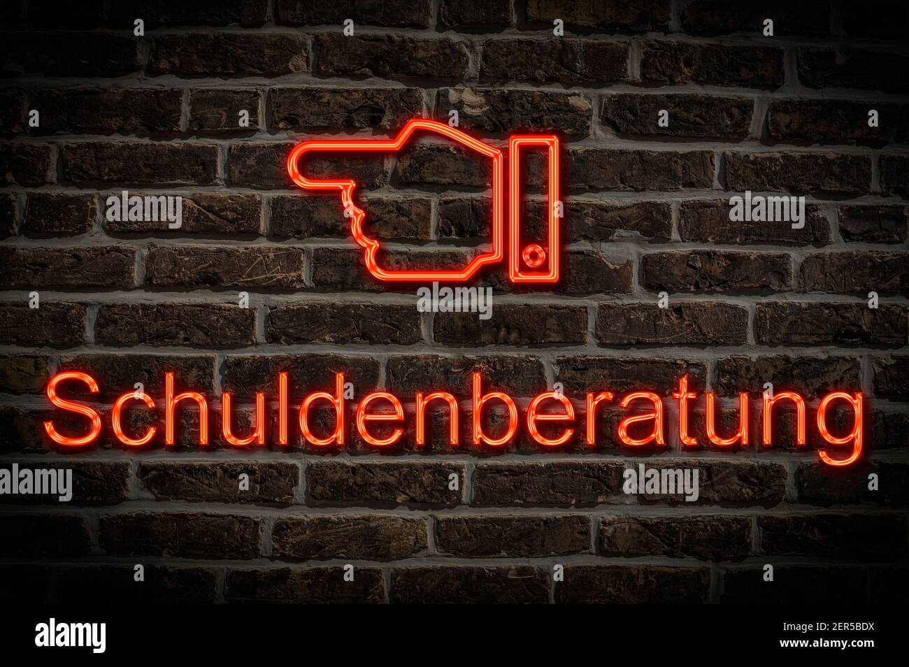 Detail photo of a neon sign on a wall with the inscription Schuldenberatung (Debt counselling) Stock Photo