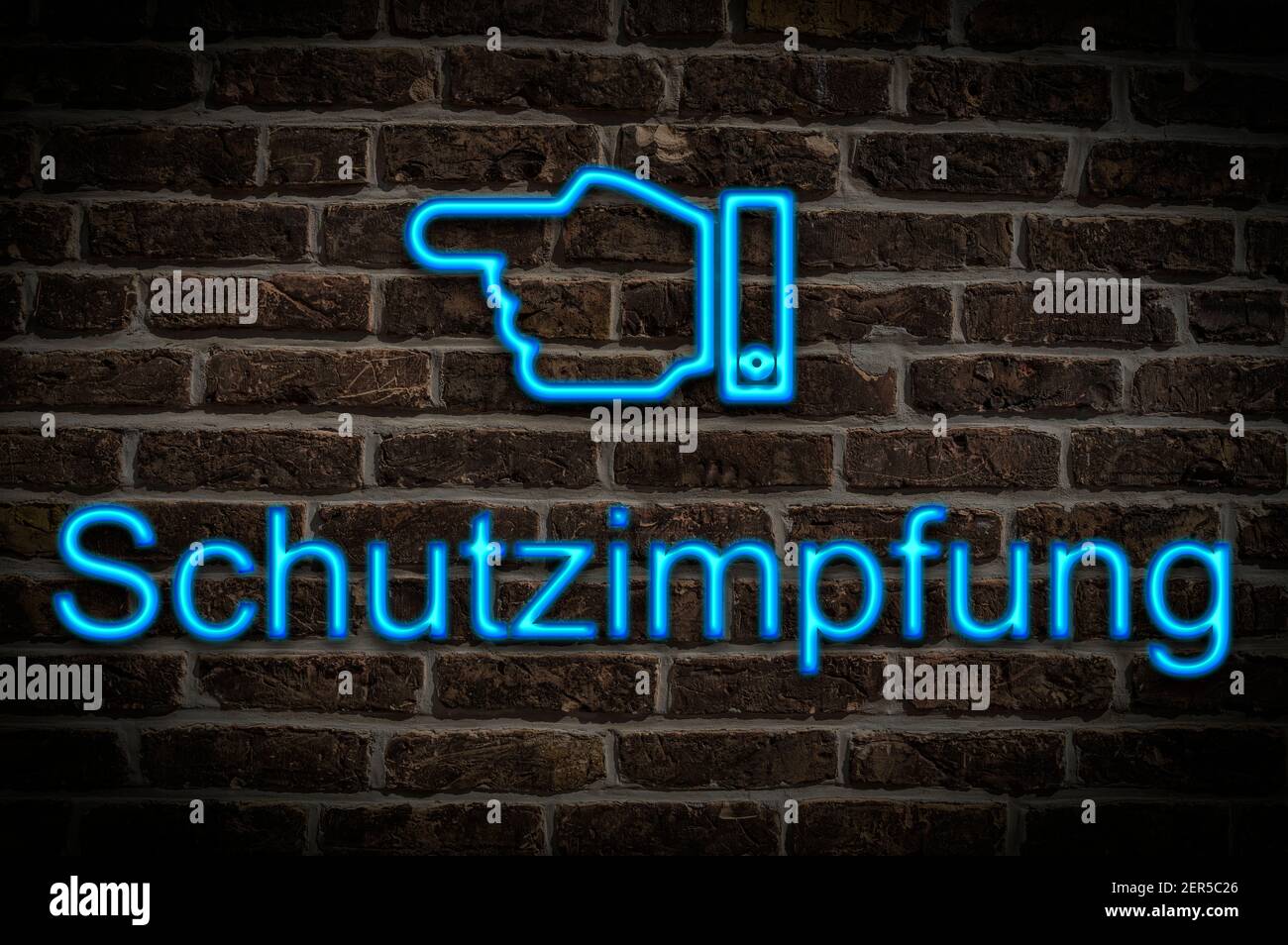 Detail photo of a neon sign on a wall with the inscription Schutzimpfung (protective vaccination) Stock Photo