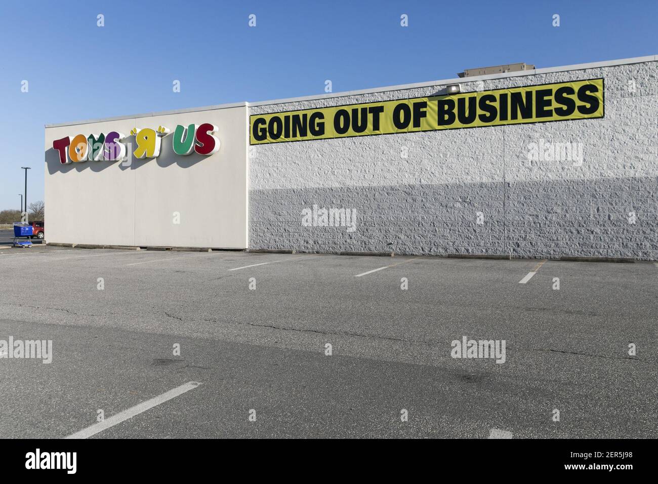 A logo sign outside of a Toys "R" Us retail store in Lancaster