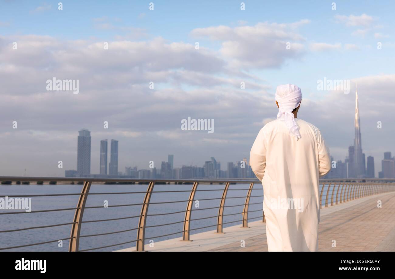 emirati Man at Al Jaddaf waterfront in Dubai with Burj Khalifa at the