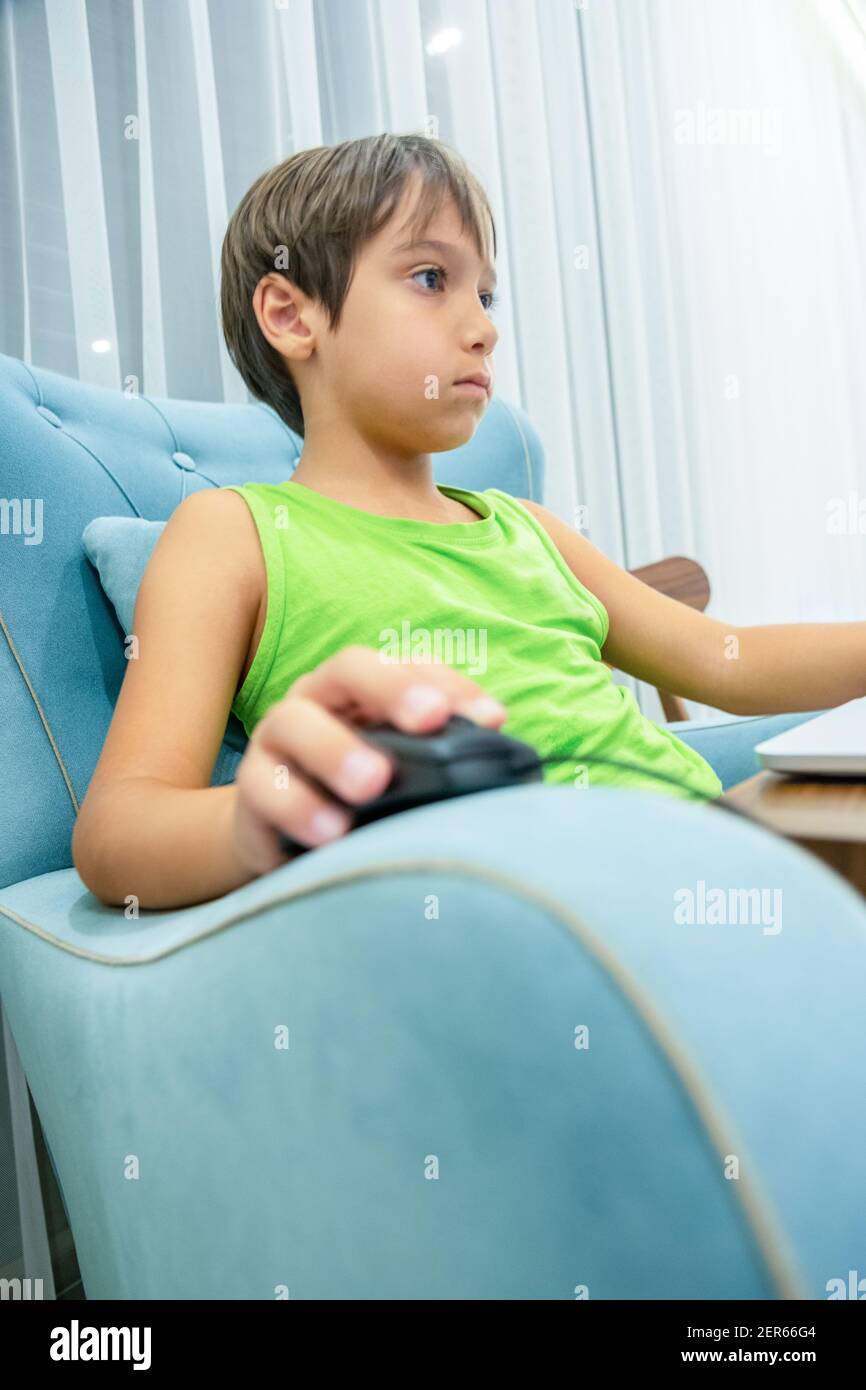 Arabic boy playing on laptop Stock Photo