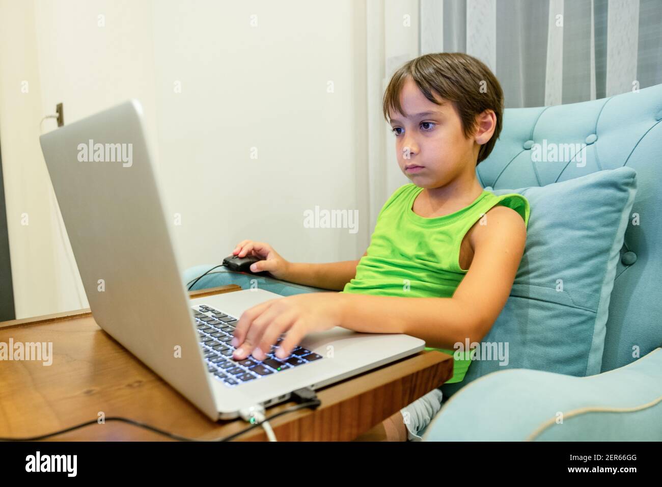 Arabic boy playing on laptop Stock Photo