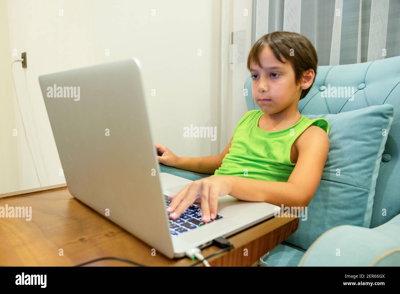 Arabic boy playing on laptop Stock Photo