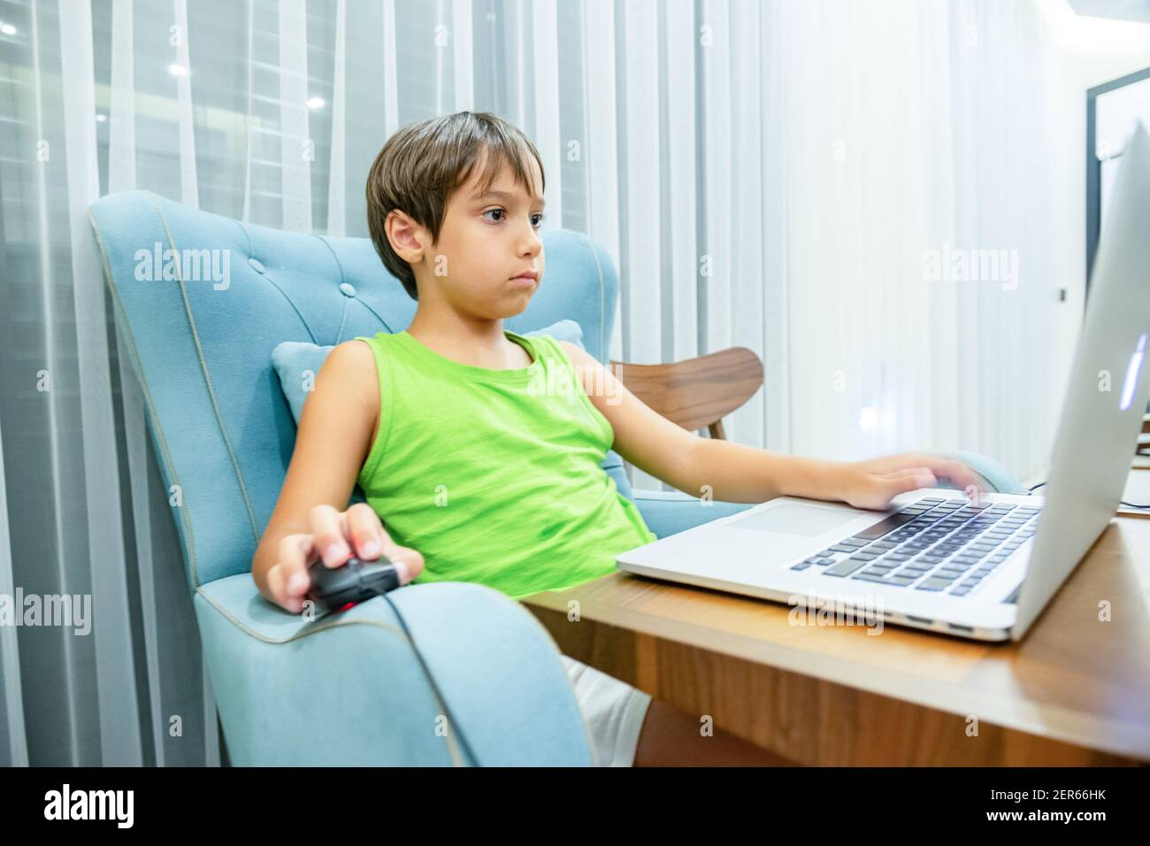 Arabic boy playing on laptop Stock Photo