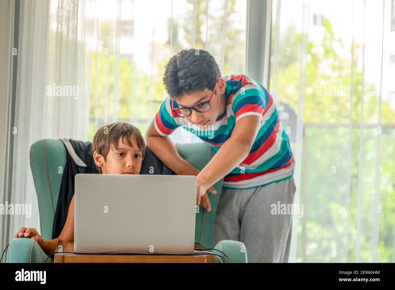 Arabic boy playing on laptop Stock Photo
