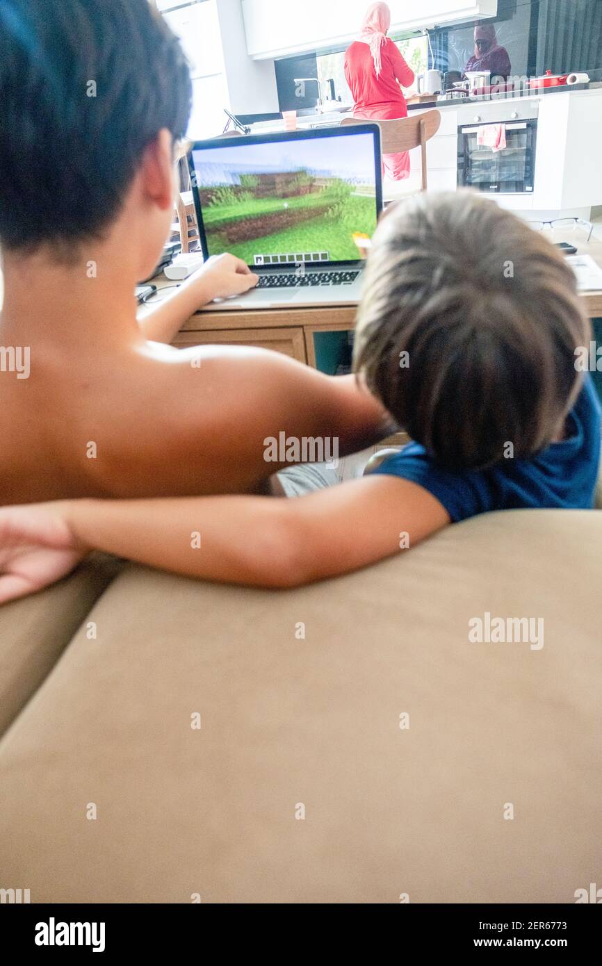 Arabic boy playing on laptop Stock Photo