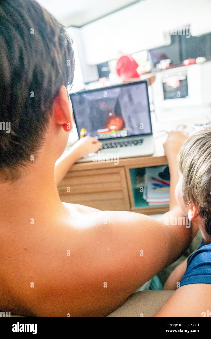 Arabic boy playing on laptop Stock Photo