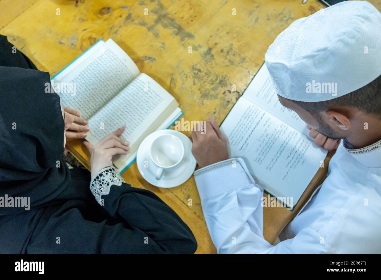 Arabic muslim people reading together and drnking some tea Stock Photo