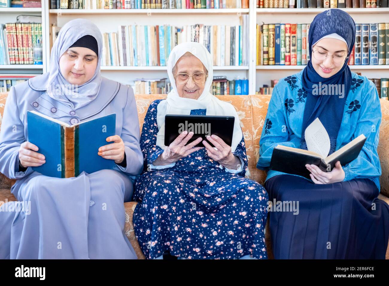 Happy Arabic Muslim Grandmother And Grand Daughter And Mother Sitting 