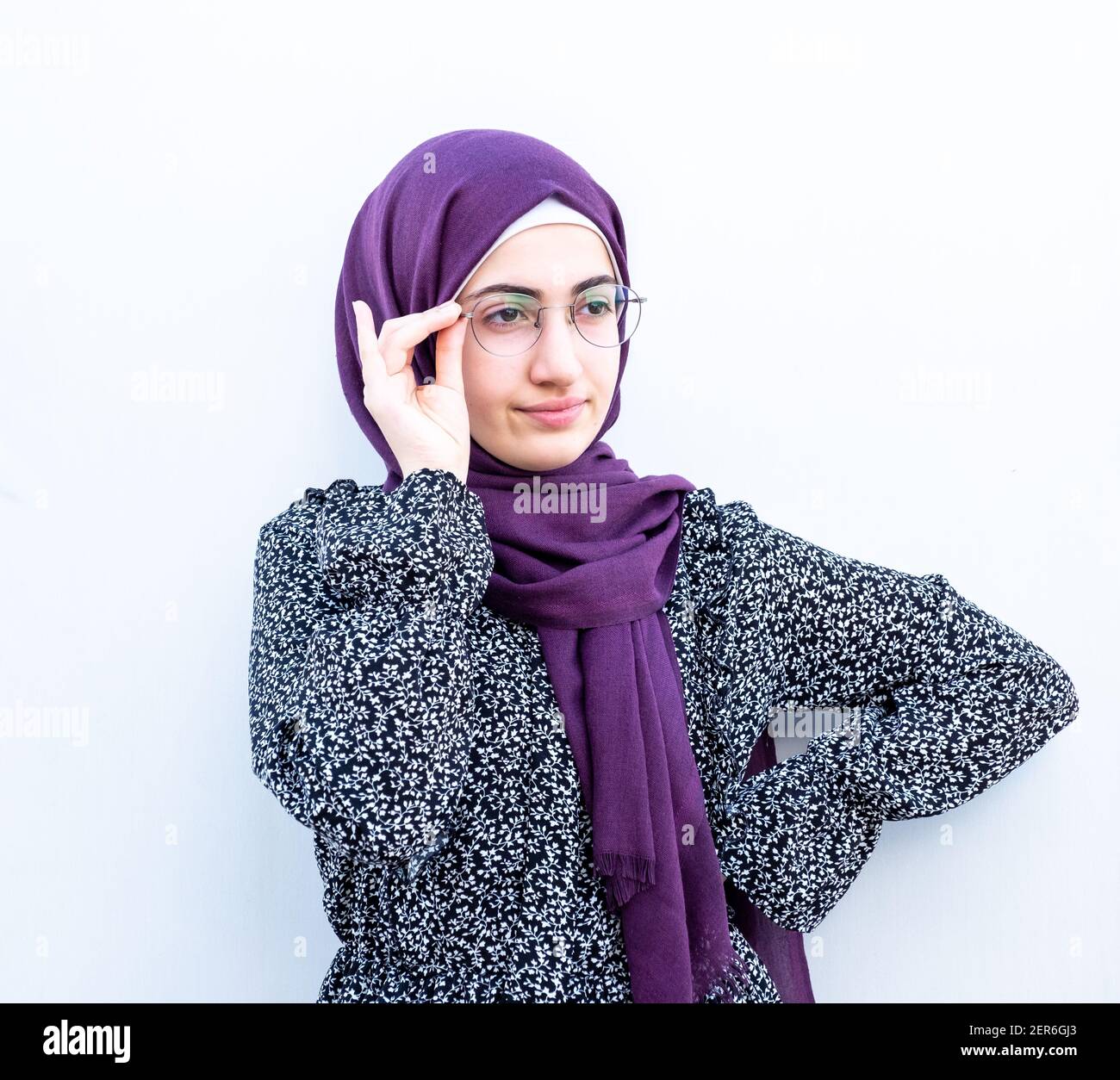 Arabic muslim girl holding her glasses on her face Stock Photo - Alamy