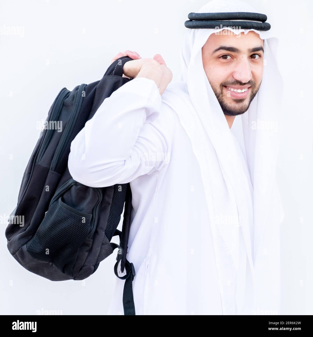 Arabic guy wearing his backpack and preparing to school Stock Photo Alamy