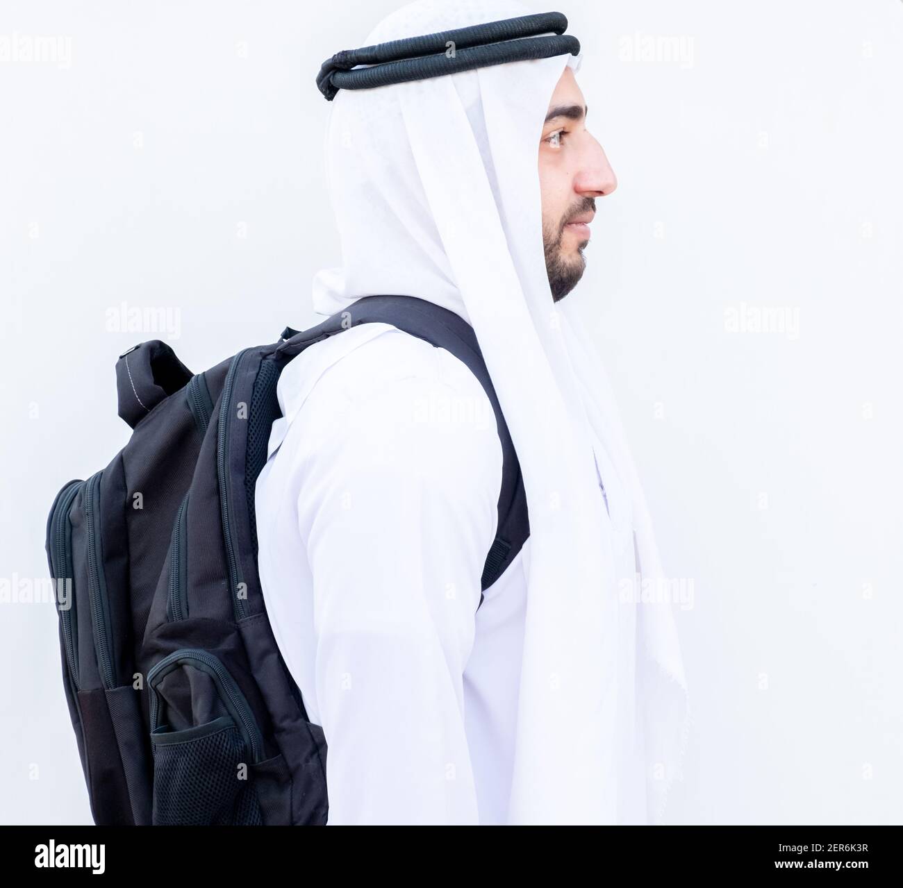 Arabic guy wearing his backpack and preparing to school Stock Photo Alamy