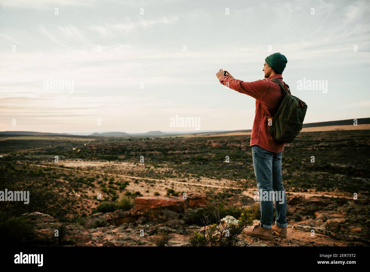 Caucasian male hiking in the wilderness taking images on cellular ...