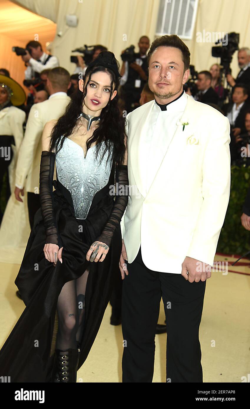 Grimes and Elon Musk attends the Costume Institute Benefit at the Metropolitin Museum of Art at the opening of Heavenly Bodies: Fashion and the Catholic Imagination on May 7, 2018 in New York, New York, USA. Stock Photo